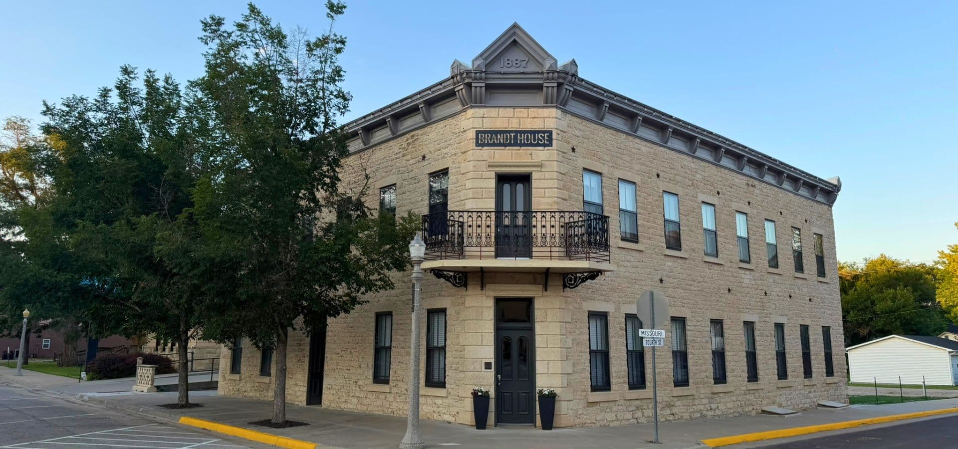 Historic stone building with a balcony, titled "Briant House."