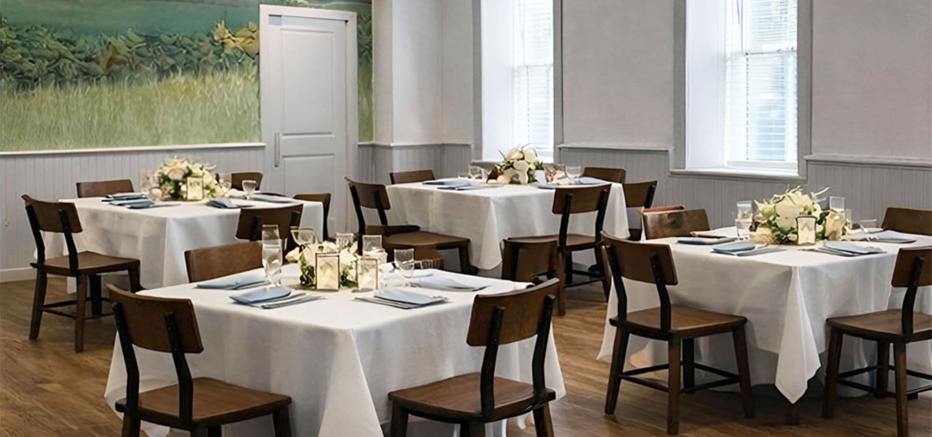 A well-decorated dining room with neatly set tables and wooden chairs.