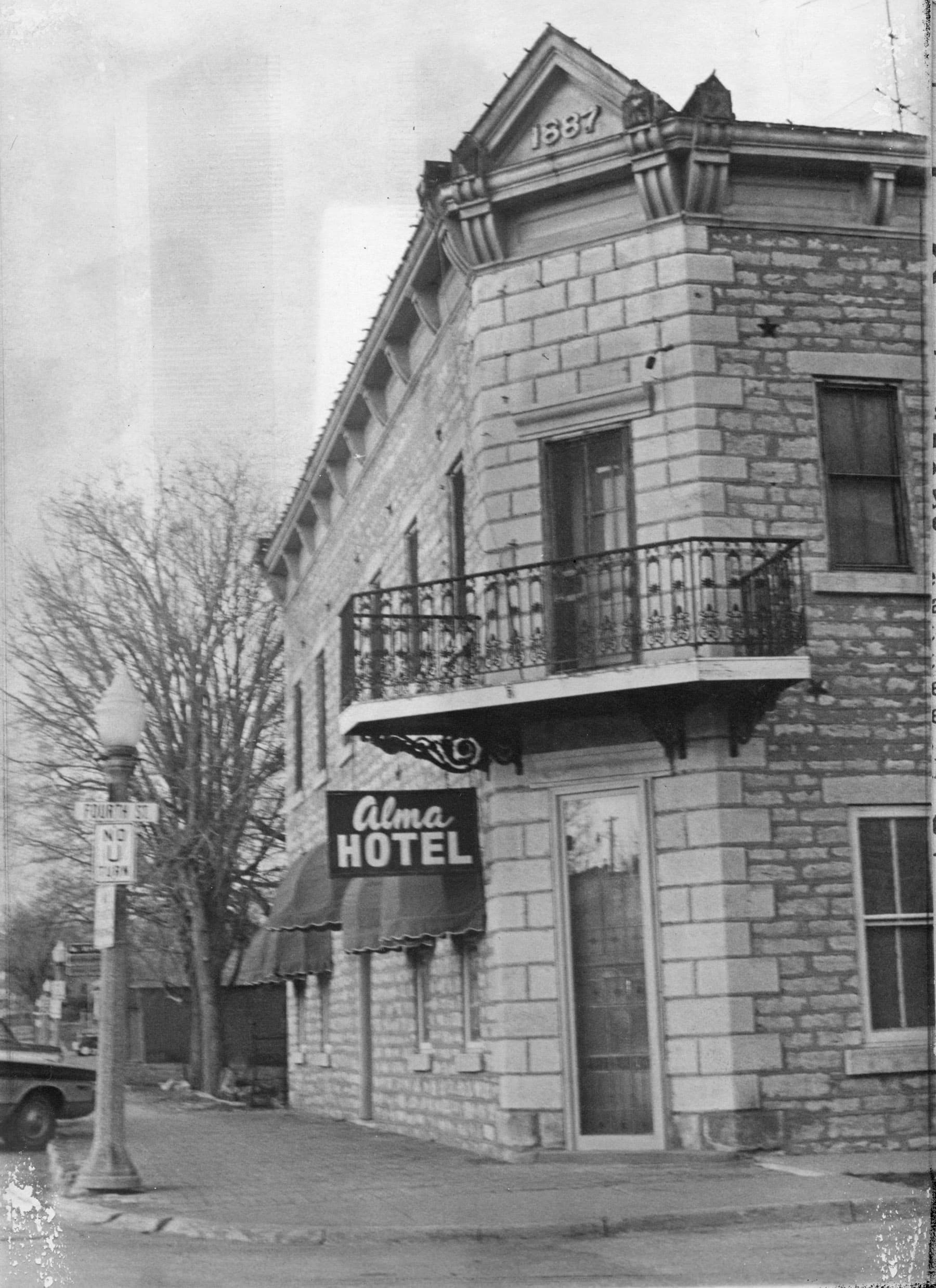 Historic Alma Hotel building with a balcony, circa 1887.