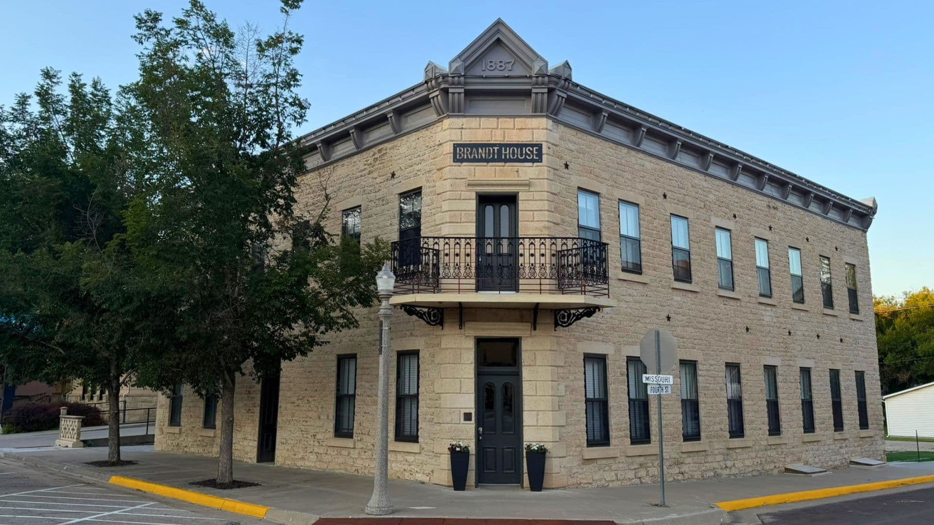 Historic building called "Brunot House" with a stone facade and a balcony.
